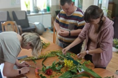 Uczestnicy tworzą kompozycję kwiatową na warsztatach florystycznych