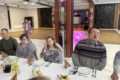 Uczestnicy ŚDS siedzą przy stole podczas Zabawy Integracyjnej w Kraśniku